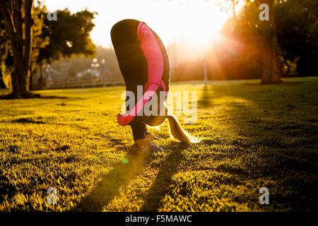 Woman stretching in park Stock Photo