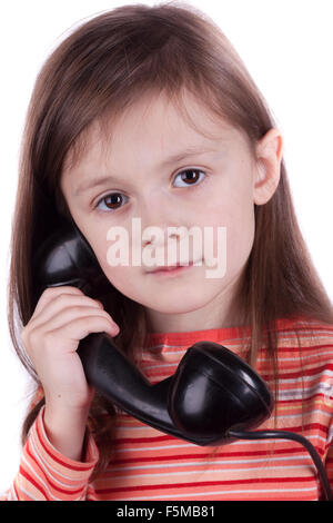 Serious sad child talking on phone, white background Stock Photo