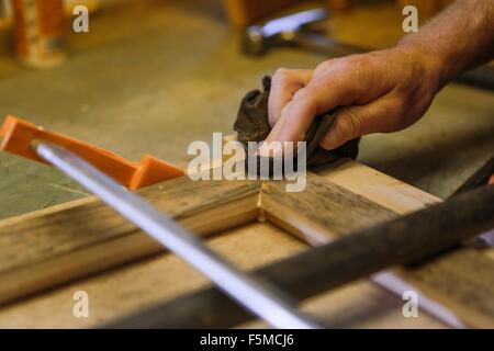 Wood artist working in workshop, close-up Stock Photo