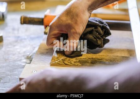 Wood artist working in workshop, close-up