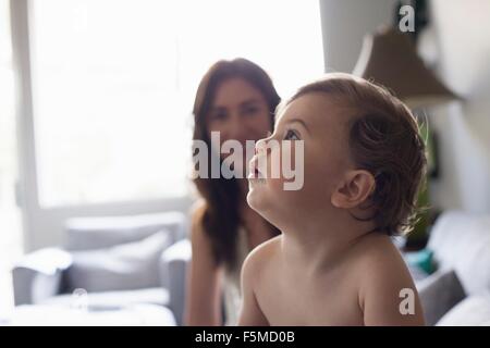 Head and shoulder side view of baby boy looking up Stock Photo