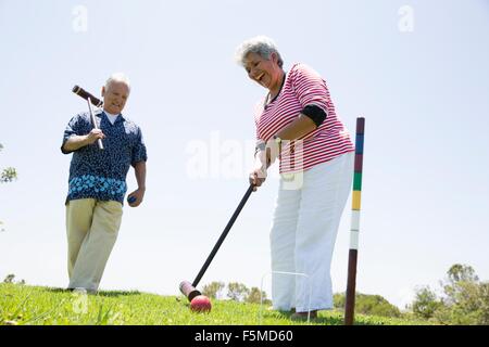 Senior couple playing croquet, outdoors Stock Photo