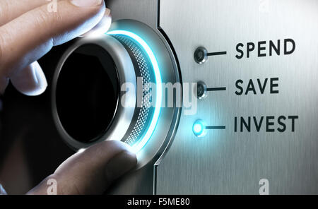 Man hand turning a knob in the invest position,  Concept image for illustration of making an investment versus saving or spendin Stock Photo