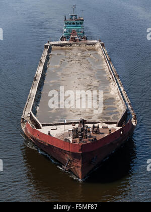 Tug boat towing a barge on the river Stock Photo