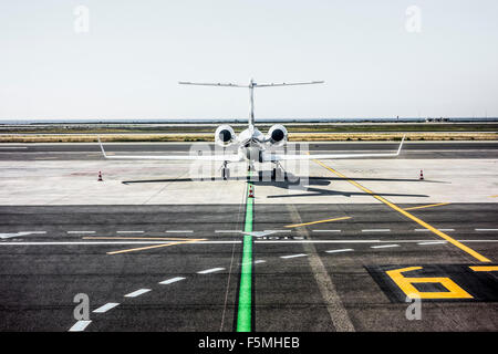 Rear view of a private jet on the runway Stock Photo