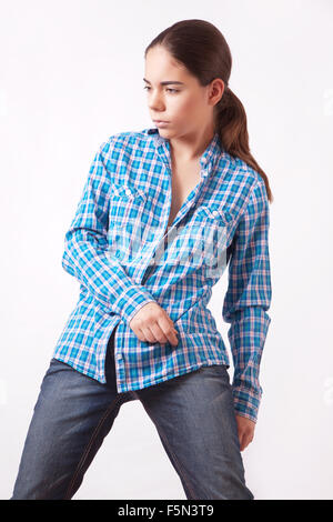 Attractive young woman in a blue shirt and jeans Stock Photo