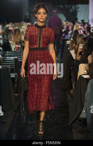 Calgary, Alberta, Canada. 6th Nov, 2015. A female model walks the Catwalk at HOLT RENFREW's Fashion Gala in Calgary wearing a dress by SELF PORTRAIT and carrying a handbag by GIVENCHY. Credit:  Baden Roth/ZUMA Wire/Alamy Live News Stock Photo