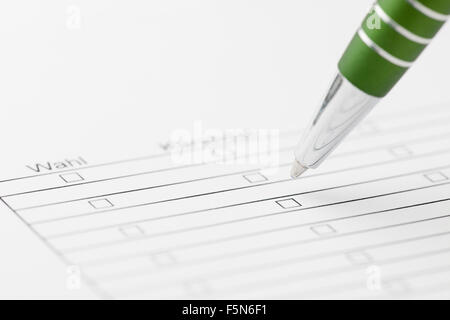 Close up of a green pen on a choice form with printed lines and boxes, and the word "Choice" in focus Stock Photo