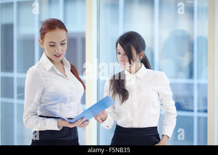 Two young beautiful businesswomen having meeting in modern office Stock Photo