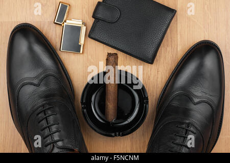 Male still life, classic men's shoes and a cigar in an ashtray, can use as background Stock Photo