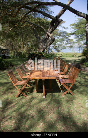 Unoccupied table and chairs on lawns at Elsamere Lake Naivasha Kenya Stock Photo