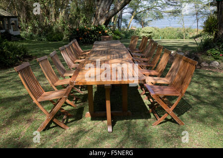 Unoccupied table and chairs on lawns at Elsamere Lake Naivasha Kenya Stock Photo