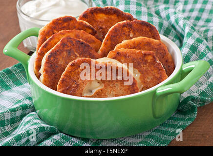 Cottage cheese pancakes in bowl Stock Photo