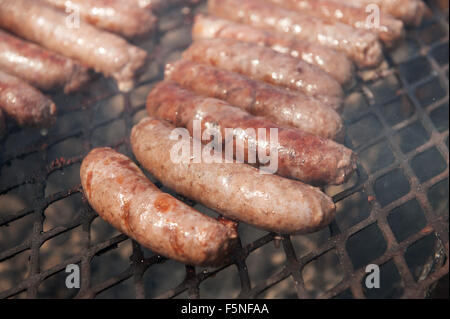 Traditional South African boervors sausages on a barbecue grill, or South African braai.  Creational South African meat sausage, know as Boerwors Stock Photo