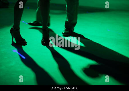 Detail of shoes with shadows in milonga ballroom. Stock Photo