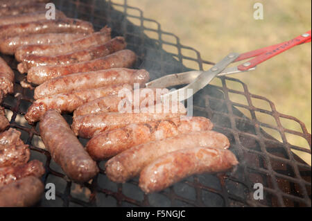 Traditional South African boervors sausages on a barbecue grill, or South African braai.  Creational South African meat sausage, know as Boerwors Stock Photo