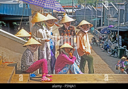 Vietnam Chao Doc Woman and Girls Wearing Conical Hats Stock Photo