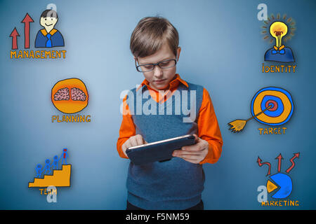 boy with glasses working on a tablet thoughtful collection of bu Stock Photo