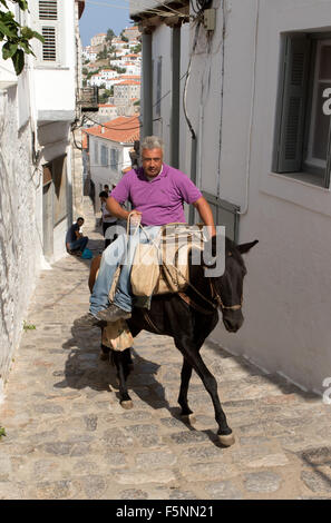 A Greek man riding his mule in Thira (Fira) on Santorini island, Greece ...