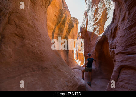 A woman admires the warm light in Peekaboo Gulch in the Escalante Canyons of Grand Staircase Escalante National Monument, Utah. Stock Photo