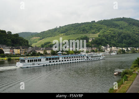 The river cruise ship Rhein Prinzessin heads up the River Moselle past the twin towns of Traben-Trarbach, Germany. Stock Photo