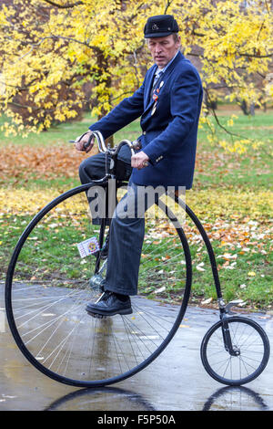 Man in traditional Penny Farthing bicycle race.riding Velocipede Stock Photo