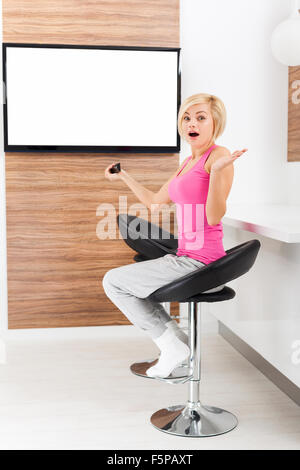 woman watching tv negative emotion scared Stock Photo