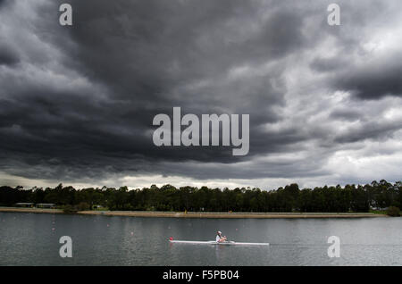 Rowers seen racing under a storm cloud at the Sydney International Regatta Centre. The Sydney International Regatta Centre was built for the 2000 Summer Olympics. Credit:  mjmediabox/Alamy Live News Stock Photo