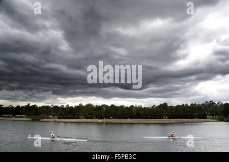 Rowers seen racing under a storm cloud at the Sydney International Regatta Centre. The Sydney International Regatta Centre was built for the 2000 Summer Olympics. Credit:  mjmediabox/Alamy Live News Stock Photo