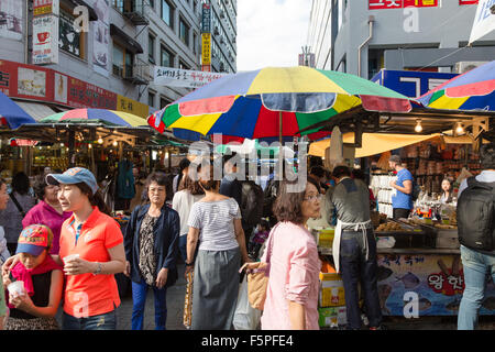 SEOUL, SOUTH KOREA - SEPTEMBER 12 2015: People wander among stalls in the busy Namdaemun market in Seoul. Stock Photo