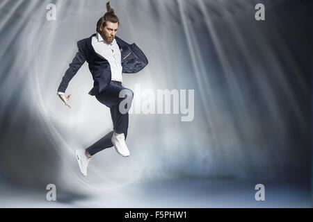 Handsome jumping businessman wearing stylish stuff Stock Photo
