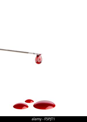 Blood dripping from the end of a syringe needle. Stock Photo