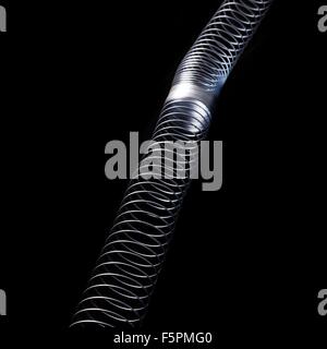 Longitudinal wave in a slinky spring. In longitudinal (or compression) waves the displacement is along the axis of propagation. Stock Photo