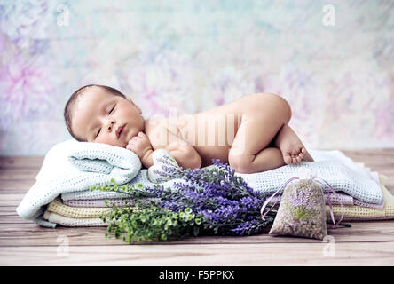 Newborn child sleeping on the colorful blanket Stock Photo