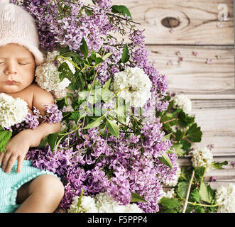 Cute child sleeping on the colorful chaplet Stock Photo