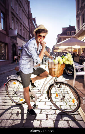 Smart guy riding a retro bicycle Stock Photo