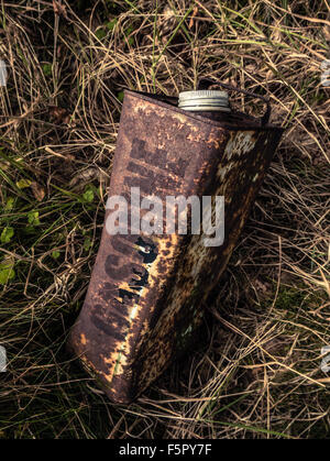 Conceptual Image Of An Old Rusty Gasoline Can Abandoned In The Undergrowth Stock Photo