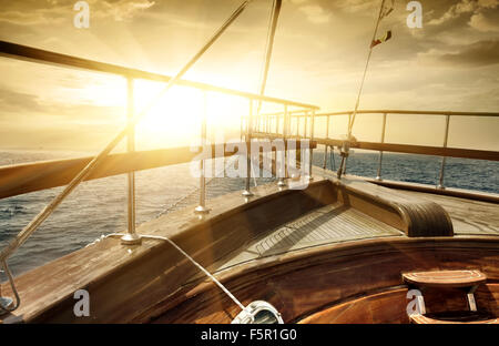 Ship in the sea in sun beams Stock Photo