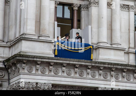 Whitehall, London, UK. 8th November, 2015. Samantha Cameron - wife of British Prime Minister David Cameron - Instructs son Arthur as they take their place on a balcony to watch the service in Whitehall. Credit:  Oliver Lynton/Alamy Live News Stock Photo
