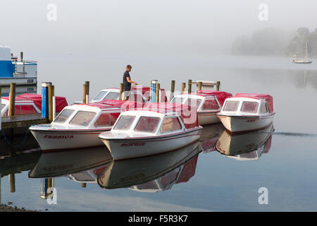 Hire boats being prepared on a misty morning on Lake Windermere