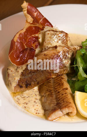 Severn & Wye Smokery,Gloucestersh,young eels(elvers)being introduced to the River Severn and pan-fried smoked eel plate.a UK Stock Photo