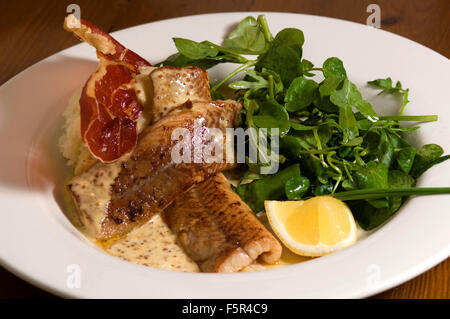 Severn & Wye Smokery,Gloucestersh,young eels(elvers)being introduced to the River Severn and pan-fried smoked eel plate.a UK Stock Photo