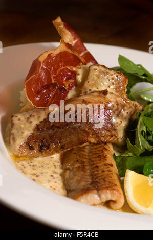 Severn & Wye Smokery,Gloucestersh,young eels(elvers)being introduced to the River Severn and pan-fried smoked eel plate.a UK Stock Photo