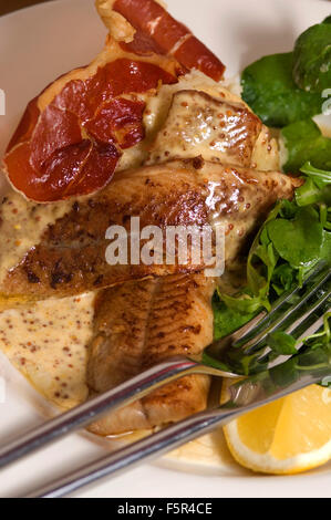 Severn & Wye Smokery,Gloucestersh,young eels(elvers)being introduced to the River Severn and pan-fried smoked eel plate.a UK Stock Photo