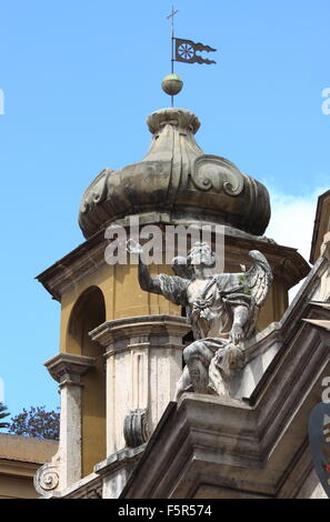 Angel statue on top of baroque church in Rome, Italy Stock Photo