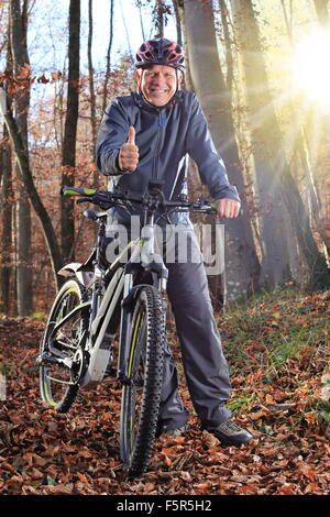 A Senior with e-bike MTB and thumb up Stock Photo