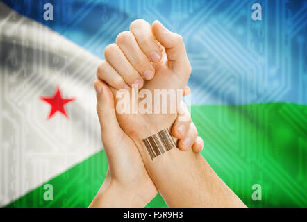 Barcode ID number on wrist of a human and national flag on background - Djibouti Stock Photo