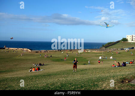 Kites in the sky and Puerto Ricans at weekend near El Morro Fort, San Juan, Puerto Rico, Caribbean Stock Photo