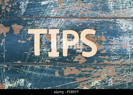 Word tips written on rustic wooden surface Stock Photo