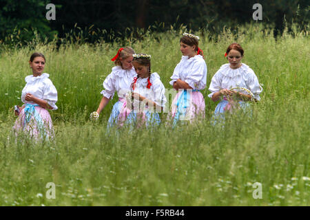 Girls. Participants in the traditional scything grass on meadow castle, Buchlovice, South Moravia, Czech Republic Stock Photo